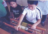 あおその繊維でさをり織りをする子ども達